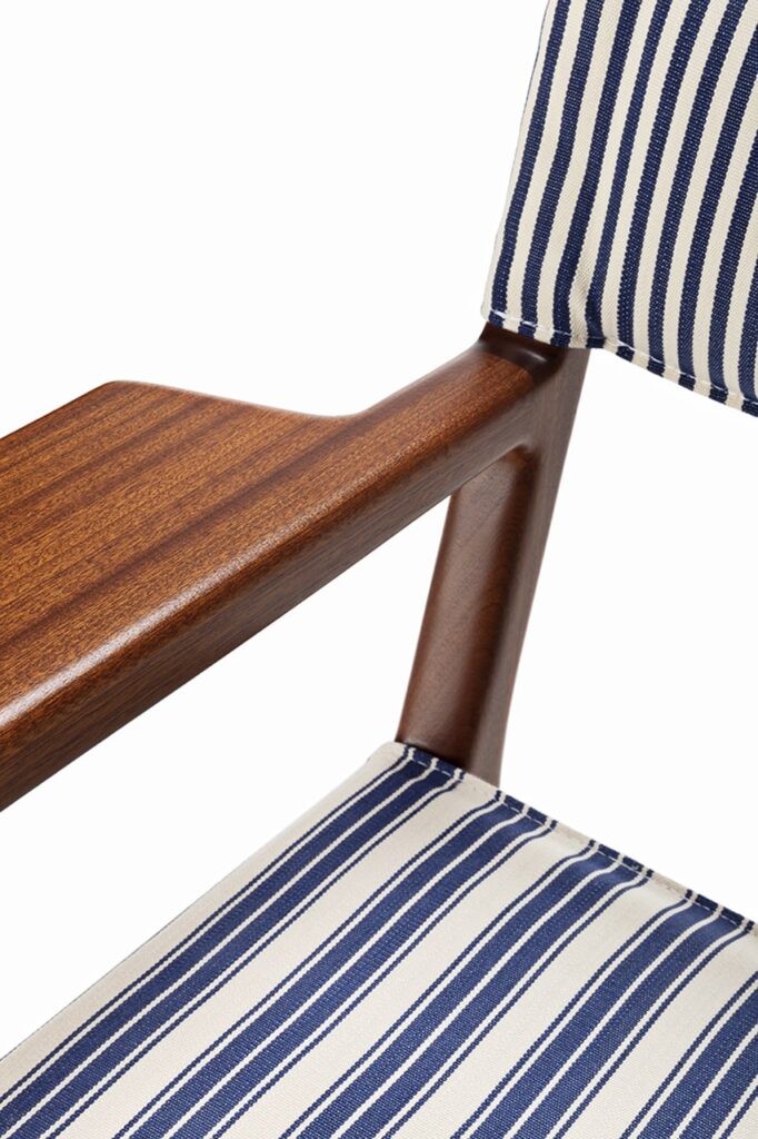 stool with light wood base and upholstered with fabric an white background