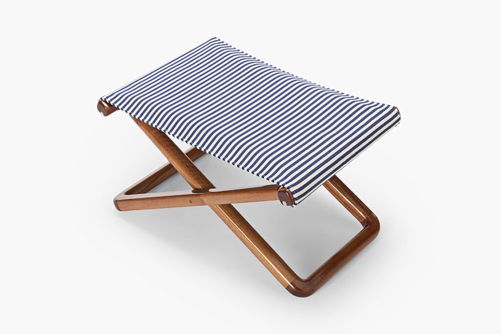 small blue stool made of wood and fabric on a white background