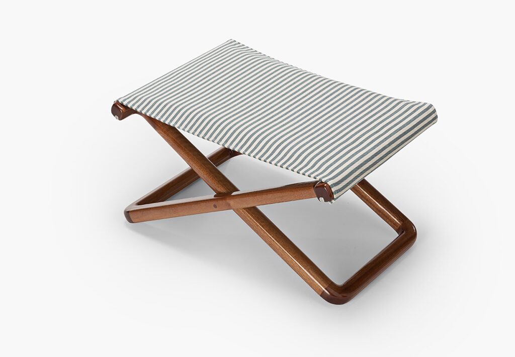 small green stool made of wood and fabric on a white background