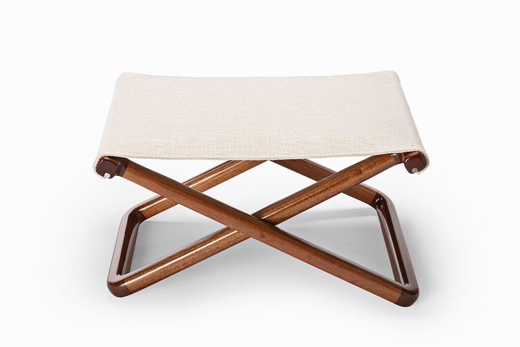 small wooden and fabric stool on a white background