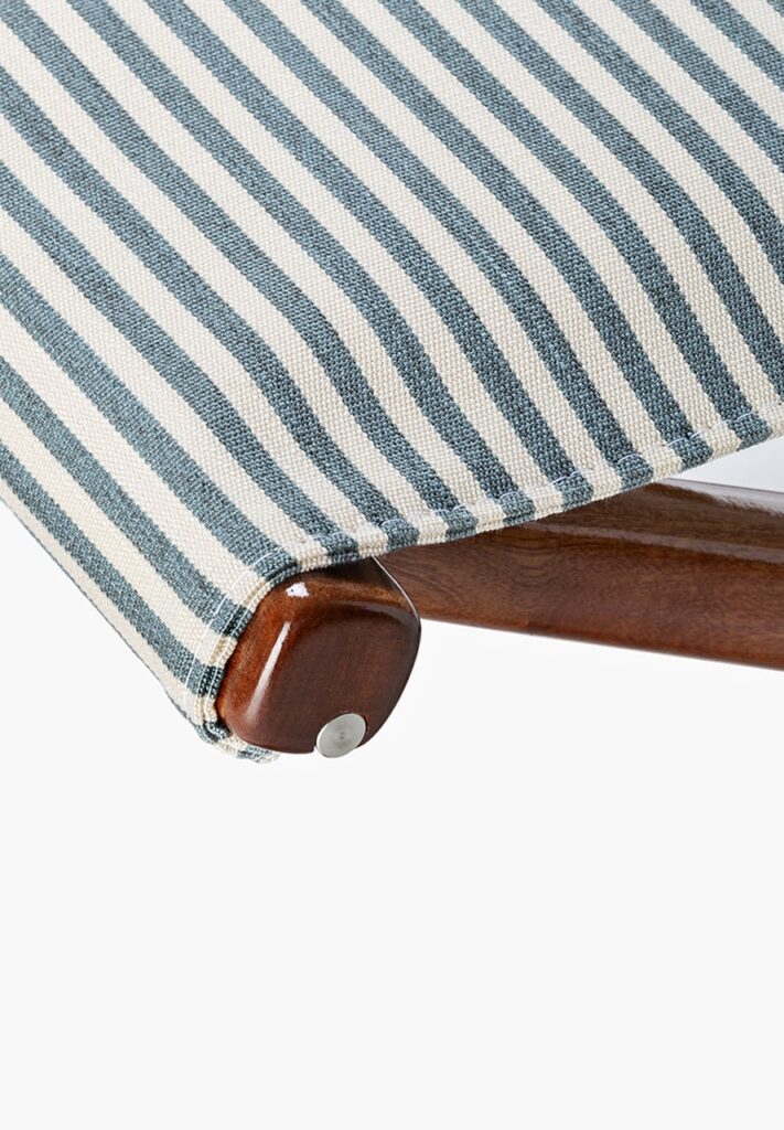 small green stool made of wood and fabric on a white background