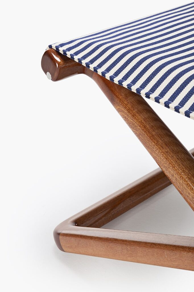 small blue stool made of wood and fabric on a white background