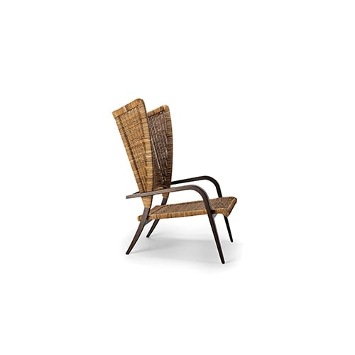 The Poltrona Bergère 1939 exudes a rich, opulent aura with its deep mahogany wood frame, which adds warmth and sophistication to any space.