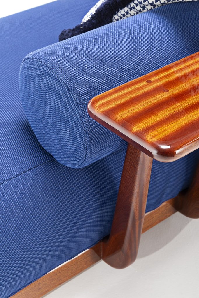 sofa with shiny and sophisticated wood finishes on a white background