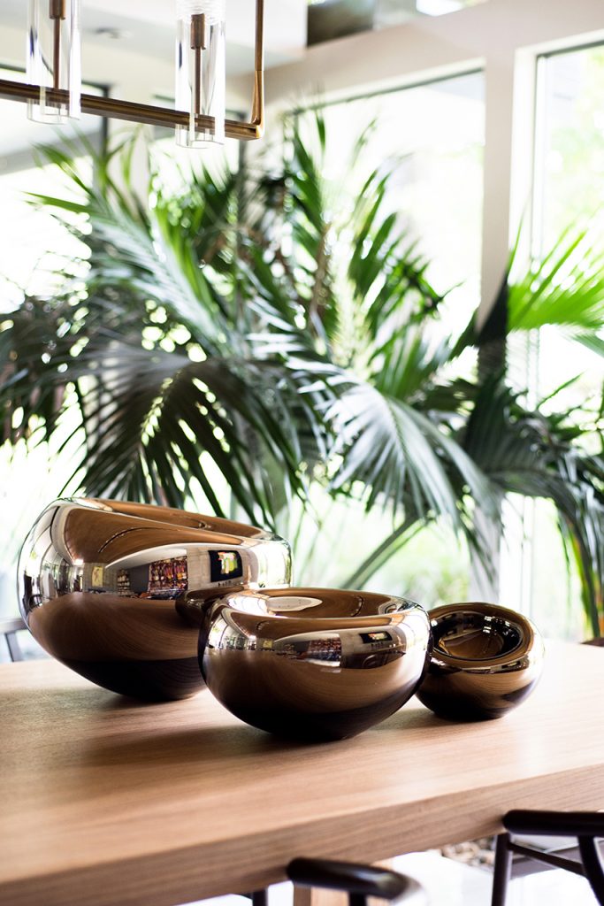 Glass pots with a brown brass finish.