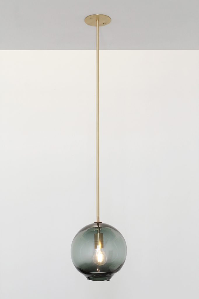 black glass spherical lamps and gold pendant.