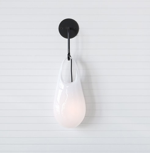 black glass vessel with a led light inside on a white background
