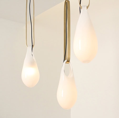 ceiling lamp with glass shades and gold steel bases a white background.