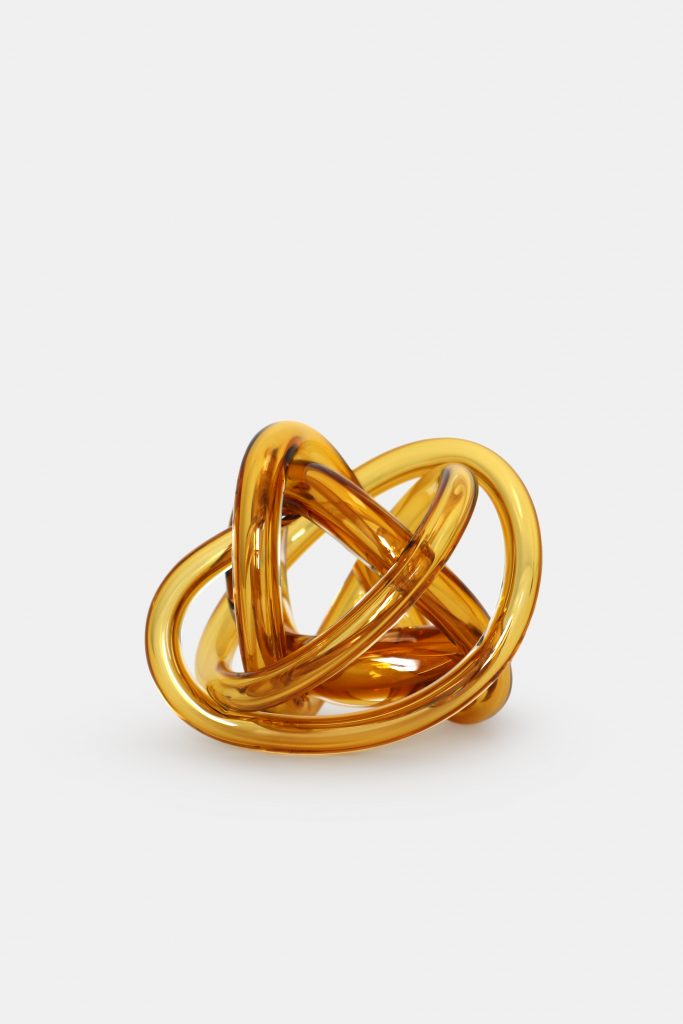 Gold colored hand blown glass tube with a braided design on a white background.