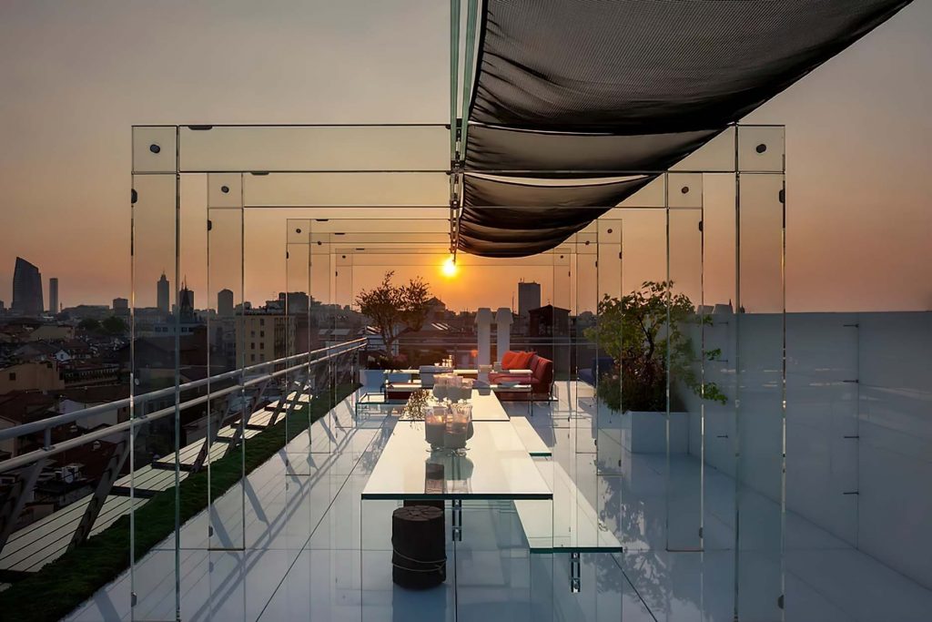 Glass pergola and four glass chairs.