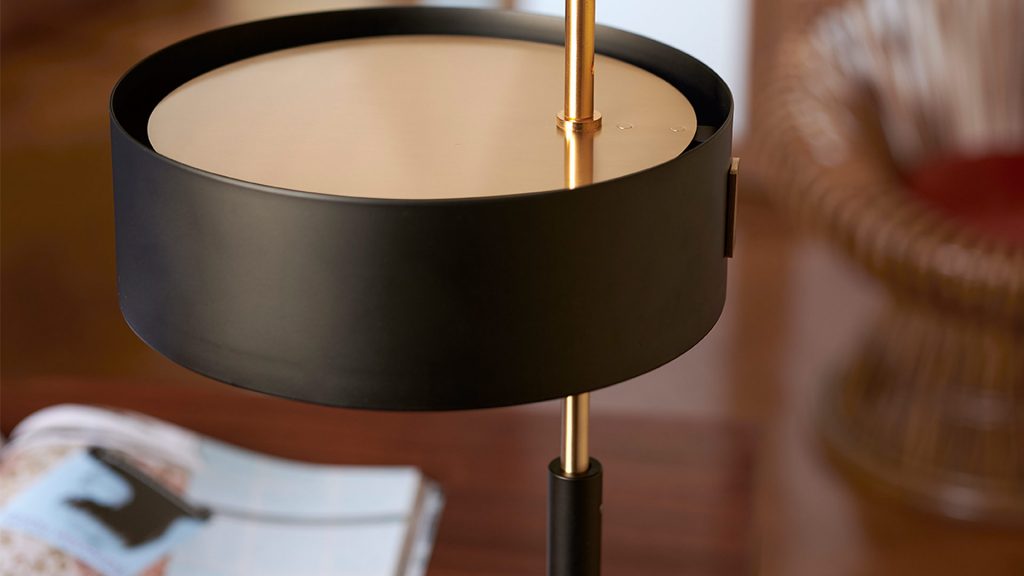 small table lamp made of aluminum and black metal with gold finishes in the shape of a semisphere