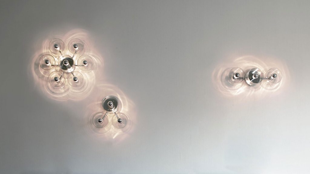 line of lamps made from fused glass in the shape of a flower