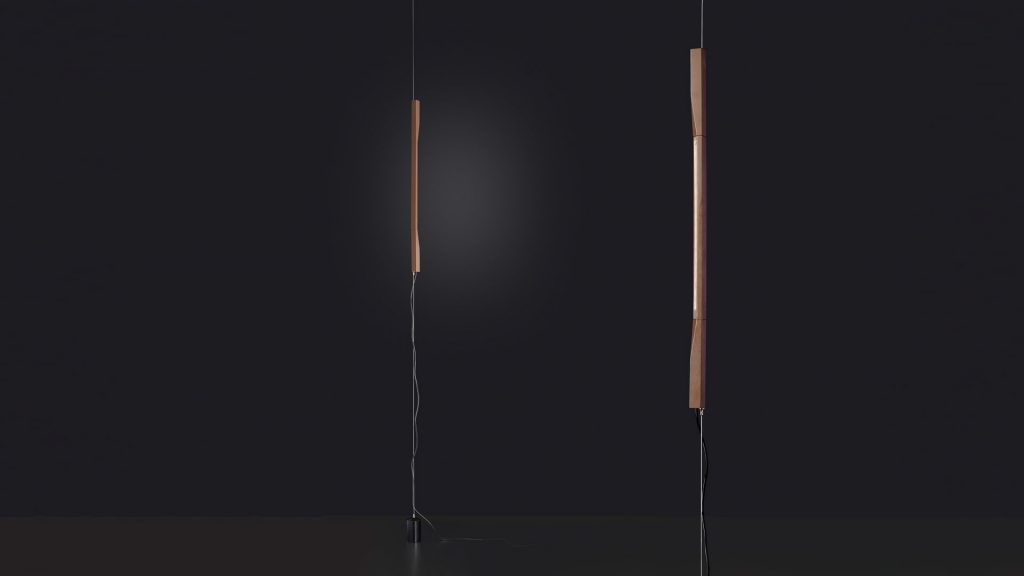 floor lamp made in the shape of a straight line made of aluminum and metal in a brown and black tone in a black background