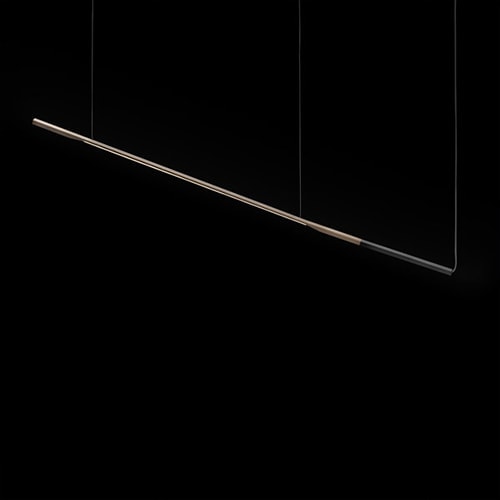 hanging lamp in the shape of a straight line made of aluminum in a gold and black tone on a black background