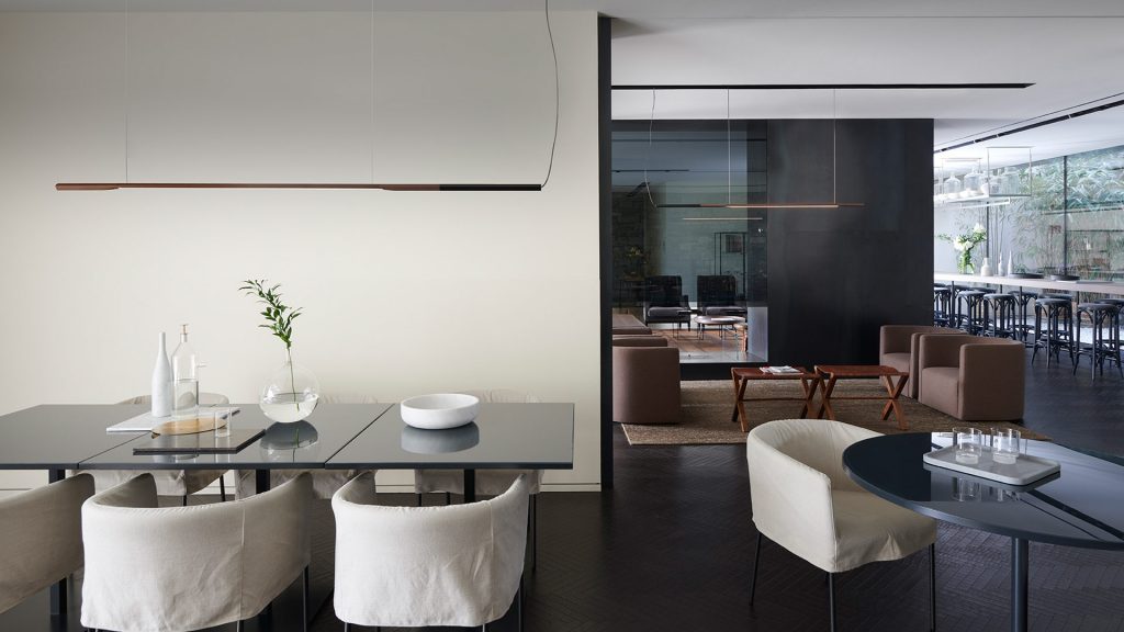 lamp made in the shape of a straight line hanging from the ceiling made of aluminum and metal in a brown and black tone
