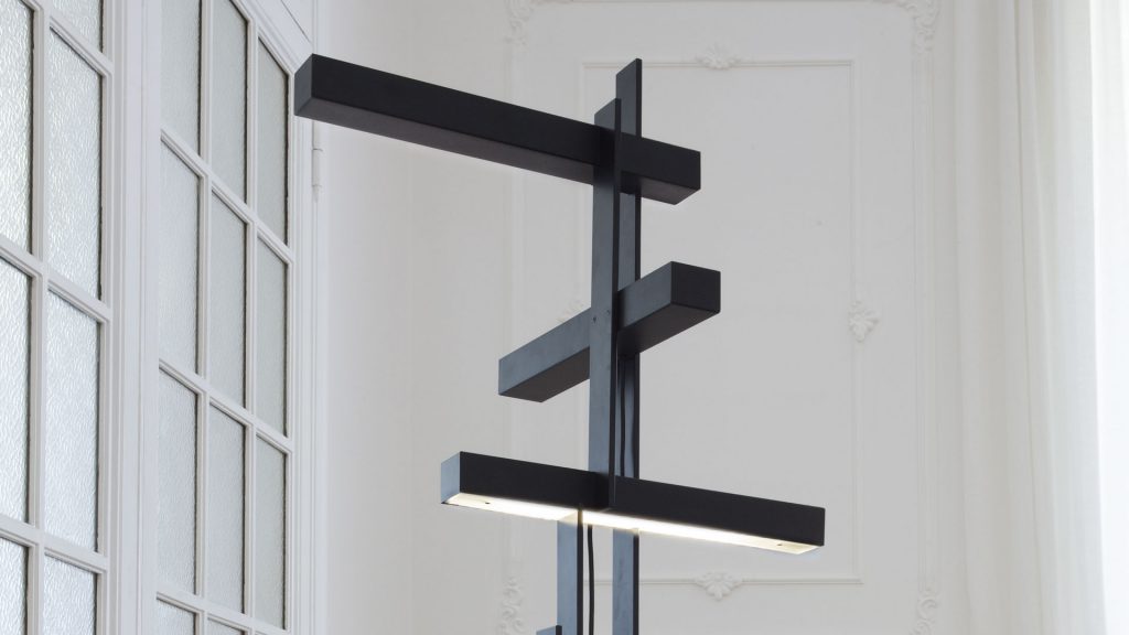 lamp made of black aluminum and LED lights in two parts of the source