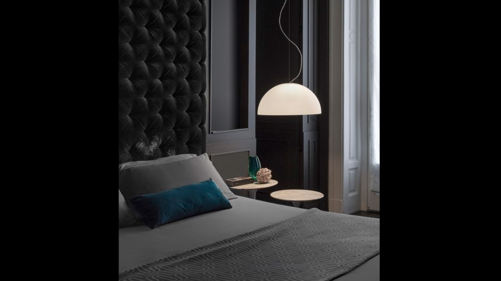 lamp made of white glass and white metal in the shape of a dome or semicircle in a room
