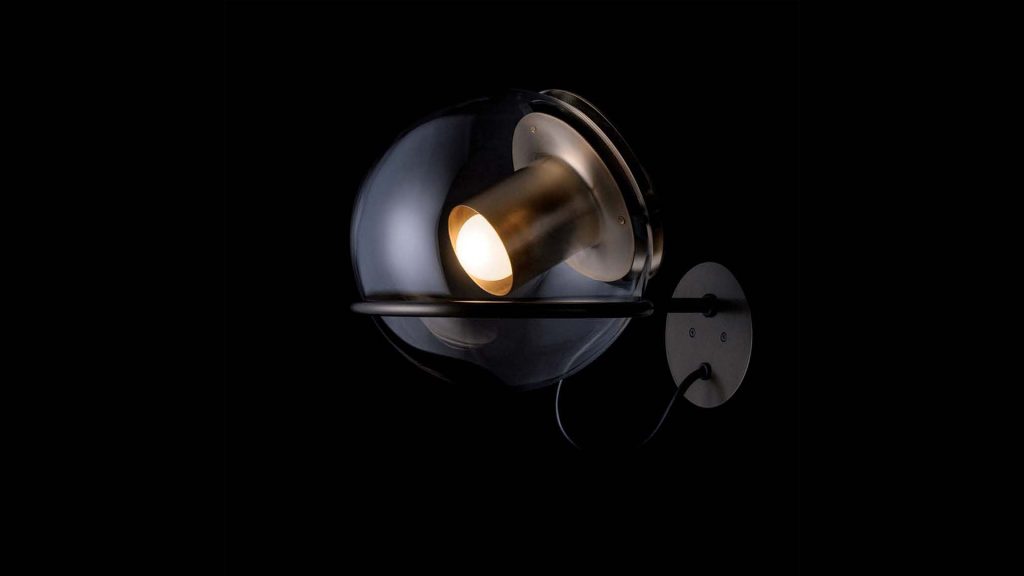 small hanging lamp made of metal base and transparent glass sphere in a blackground