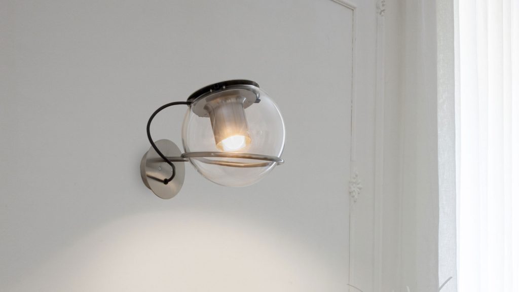 ceiling lamps in the shape of glass spheres and thin black metal bases in a white background