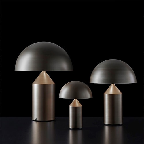 lamps made of bronze in the shape of a large and small mushroom in a black background