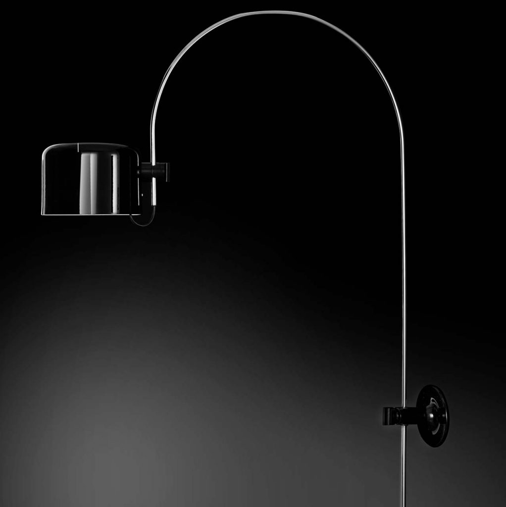 floor lamp made with a curved shape with a square head made of aluminum and metal in a black tone on a black background