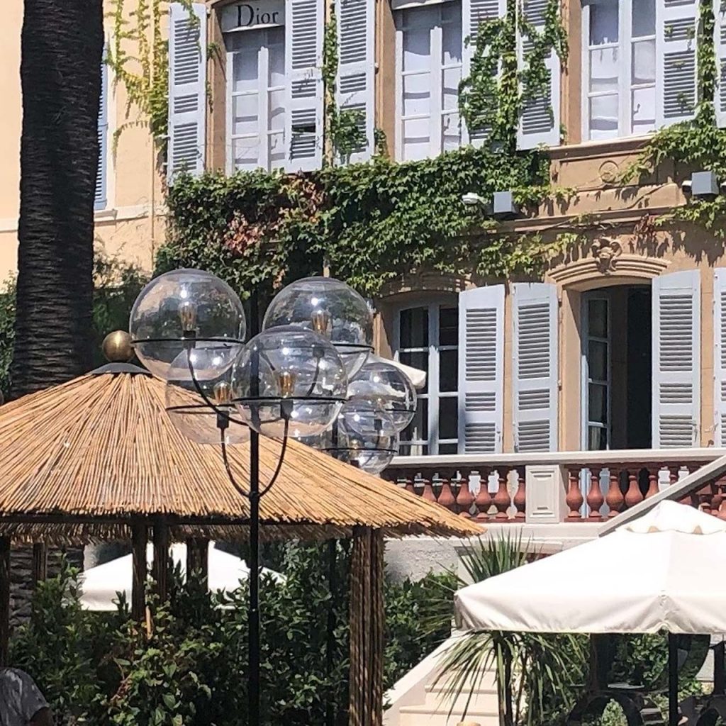 lamp with four transparent glass spheres and black metal base in an outside