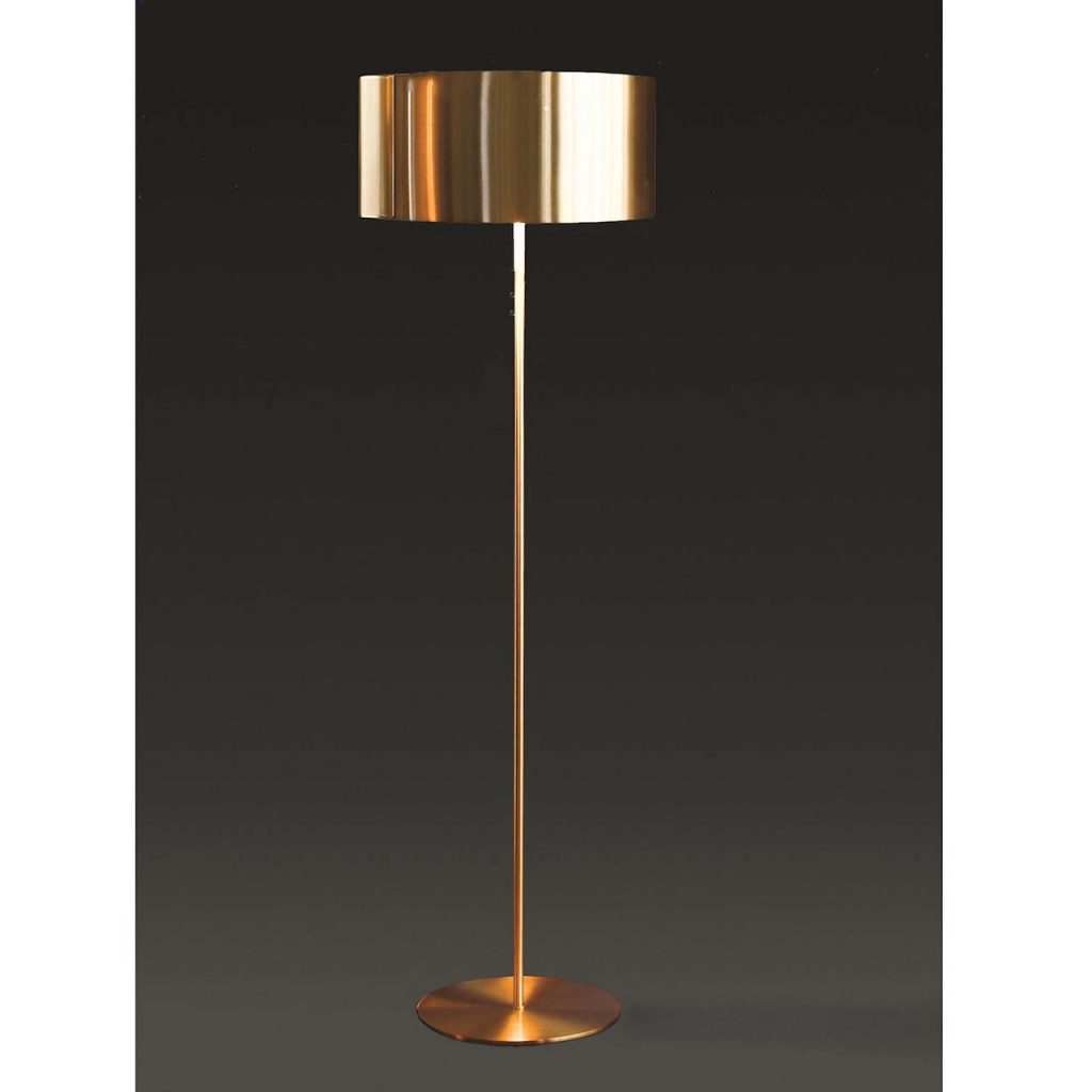floor lamp made in a cylinder shape at the top in a golden tone in a black background