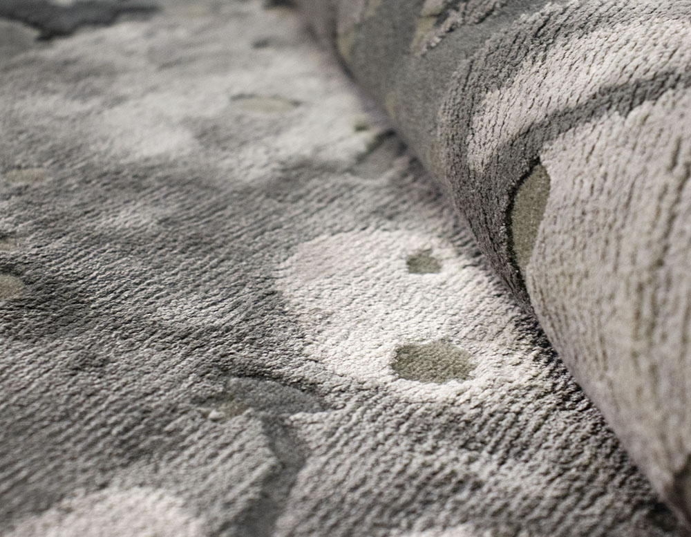 rug with shades of gray and white made with New Zealand Wool and natural silk relief in a room