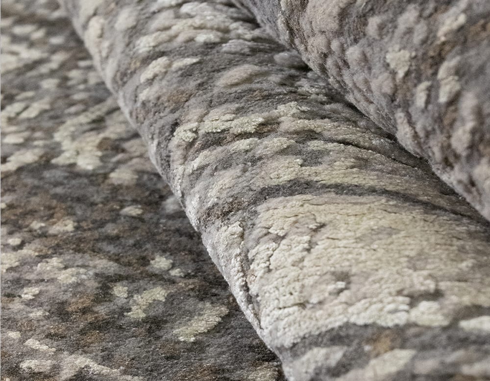 made of wool and fabric rug with imperfect linear design in a gray and brown tone