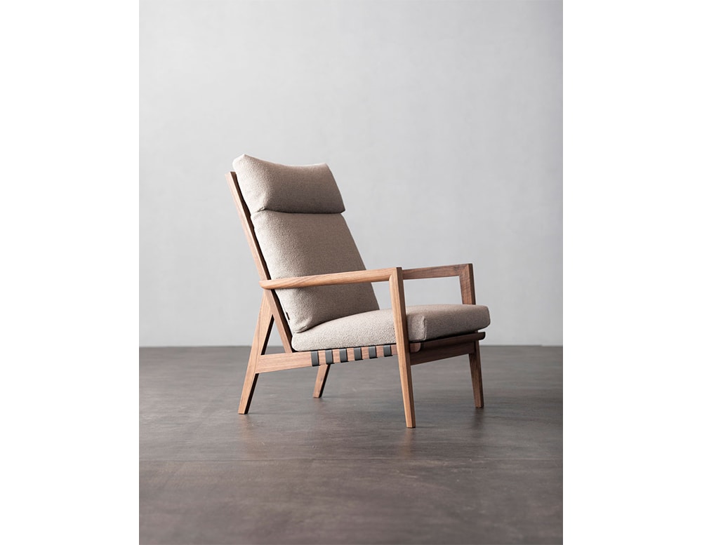 armchair made of beige fabric with brown ash wood structure