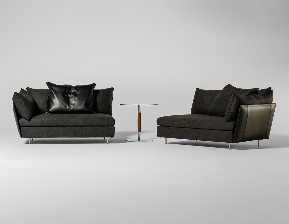line of armchairs made of steel base and black fabric on a gray background