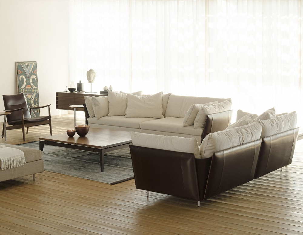 sofa made of beige fabric and dark brown finishes in a living room