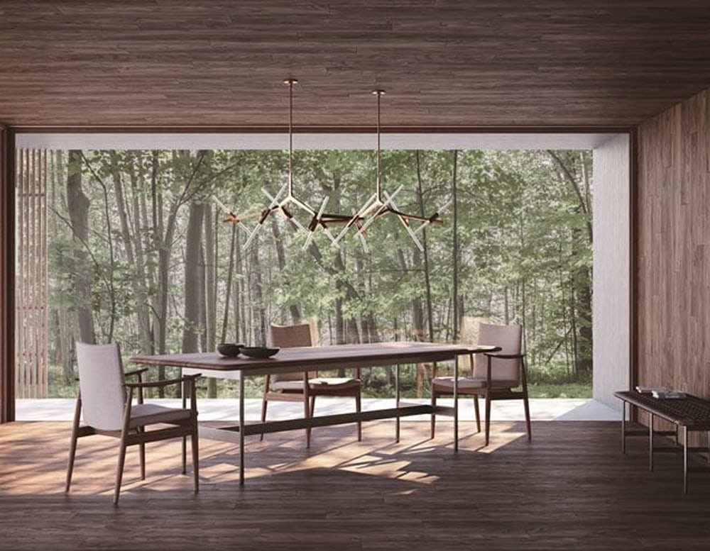 long table made of oak wood base and brown leather top on a background room