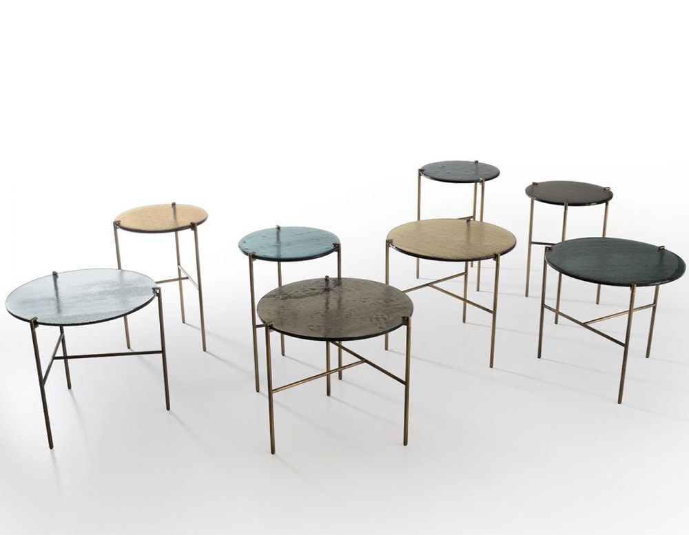 line of circular tables made of aluminum and glass of different types and colors on a white background