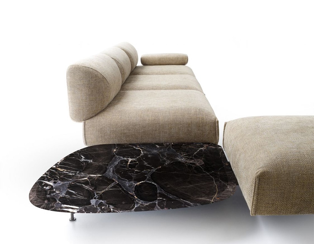 auxiliary table made of black marble with white finishes in the shape of smoke in a room on a white background