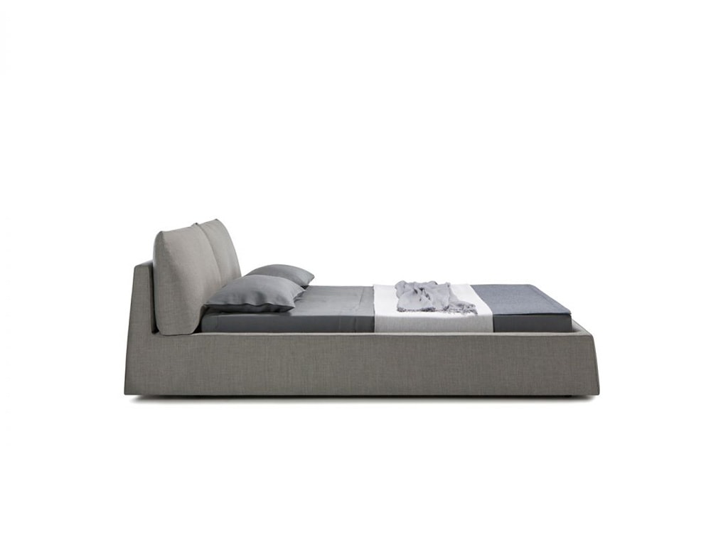 bed base made of wood and gray fabric with finishes on a white background