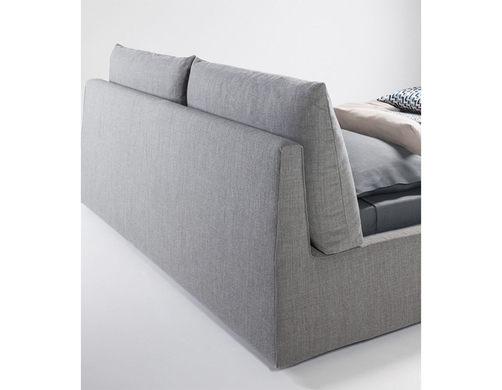 bed base made of wood and gray fabric with finishes on a white background