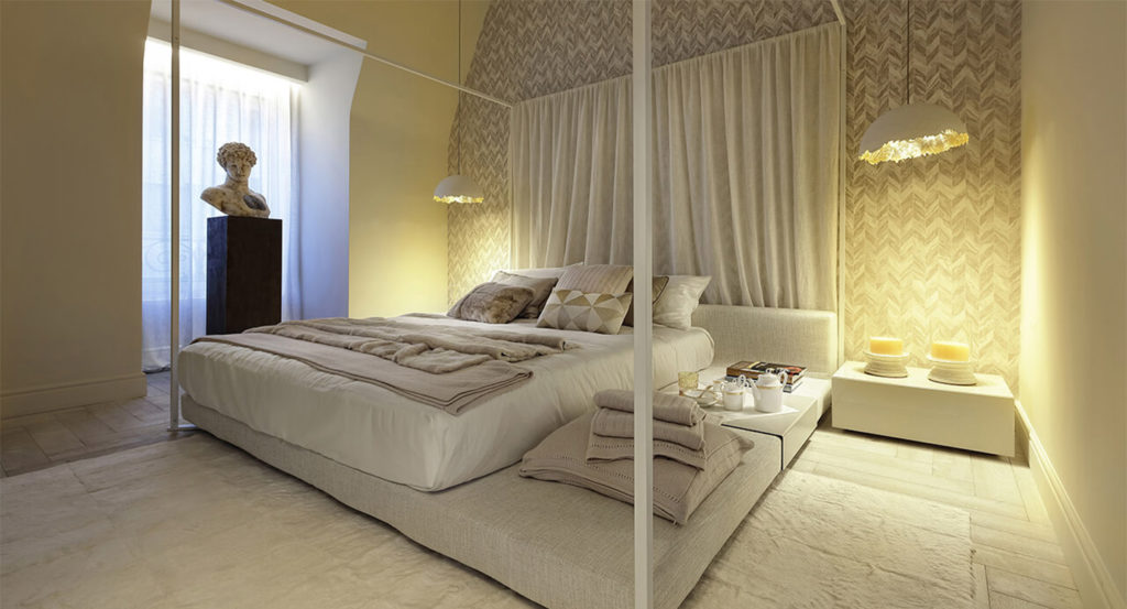 bed made of wood and white fabric with a metal structure in the shape of a cube around it