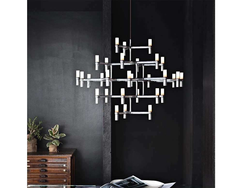 lamp made of black metal in the shape of a spider with white finishes in a living room