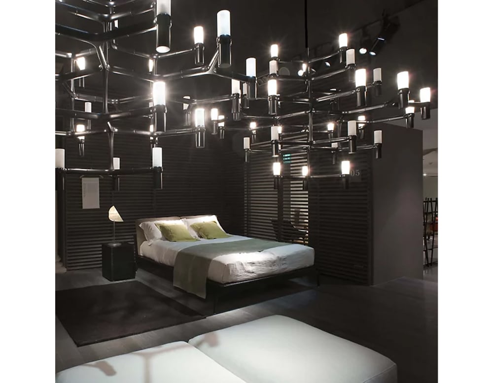 lamp with structure designed as if it were a black metal spider in a room