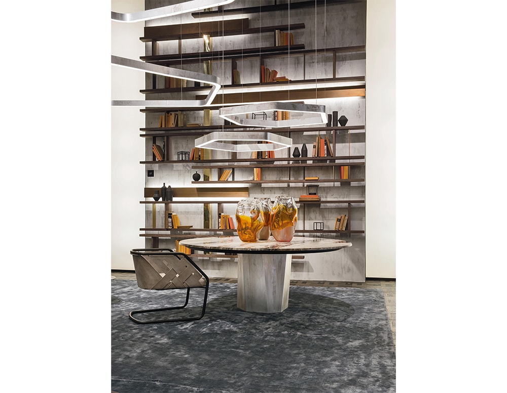 Hen Stile Set, a sophisticated dining arrangement featuring a sleek modern table, a stylish chair, and an artistic shelving unit in a contemporary interior