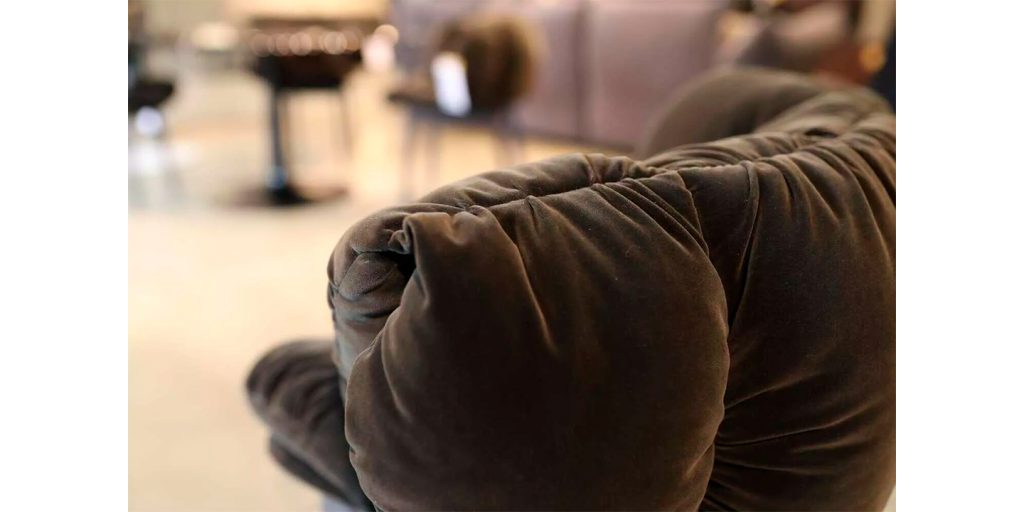 chair made of soft textured velvet plush in a dark gray tone