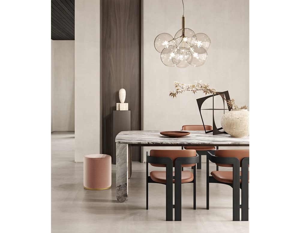 Clemo table with some chairs in front, a white wall in the background, and a chandelier hanging on top