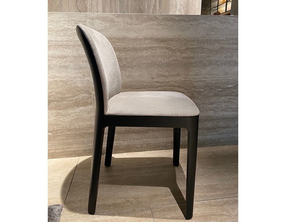 A sophisticated Tea Dining Chair featuring a sleek wooden frame and plush upholstered seat, combining comfort with timeless elegance