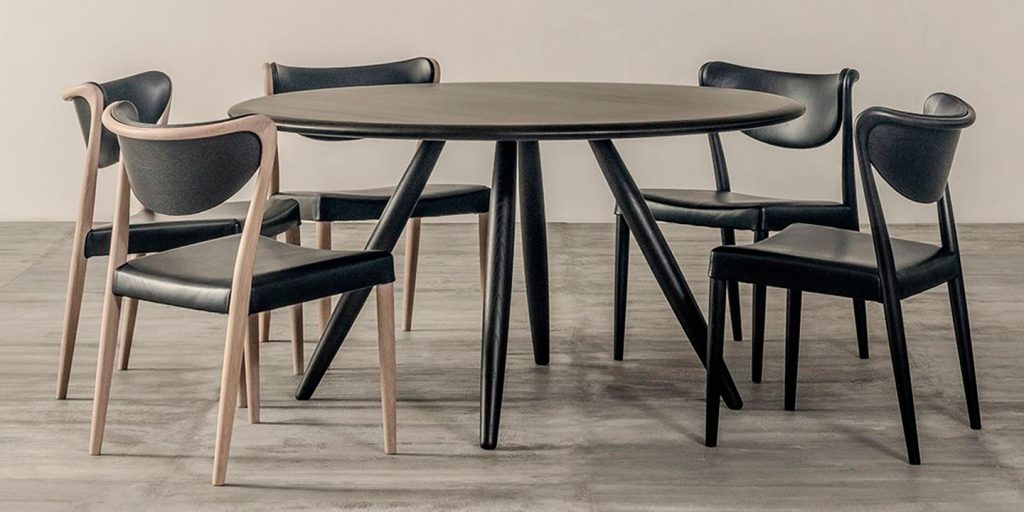 coffee table made with a four-legged base and wooden top in a black tone