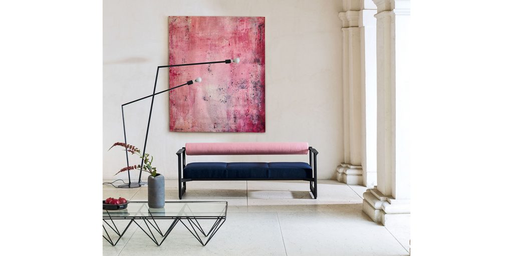 sofa made in 2 parts, the upper one in pink fabric and the lower one in blue fabric, metal bases in a living room