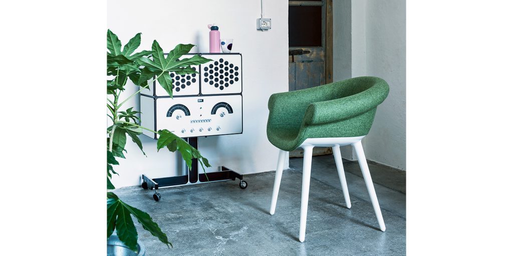 Armchair made of white polycarbonate with emerald green fabric upholstery