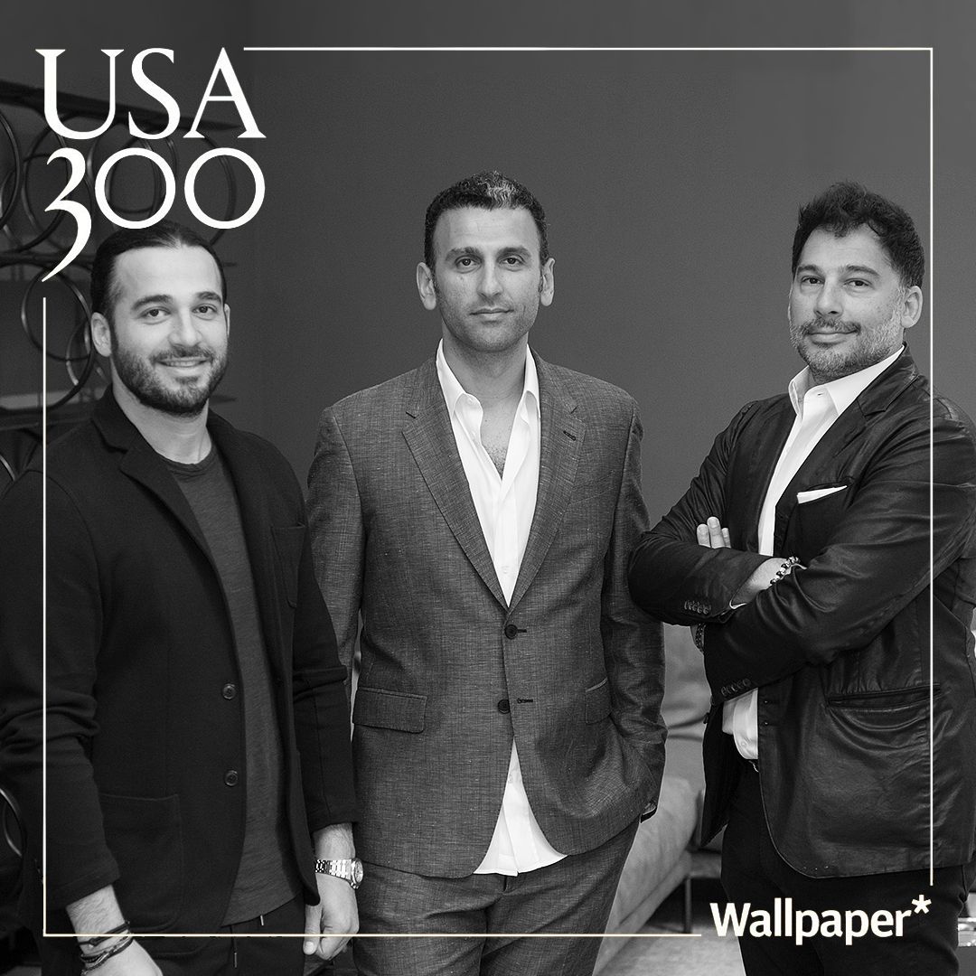 A black-and-white portrait of three professionally dressed men standing together, with 