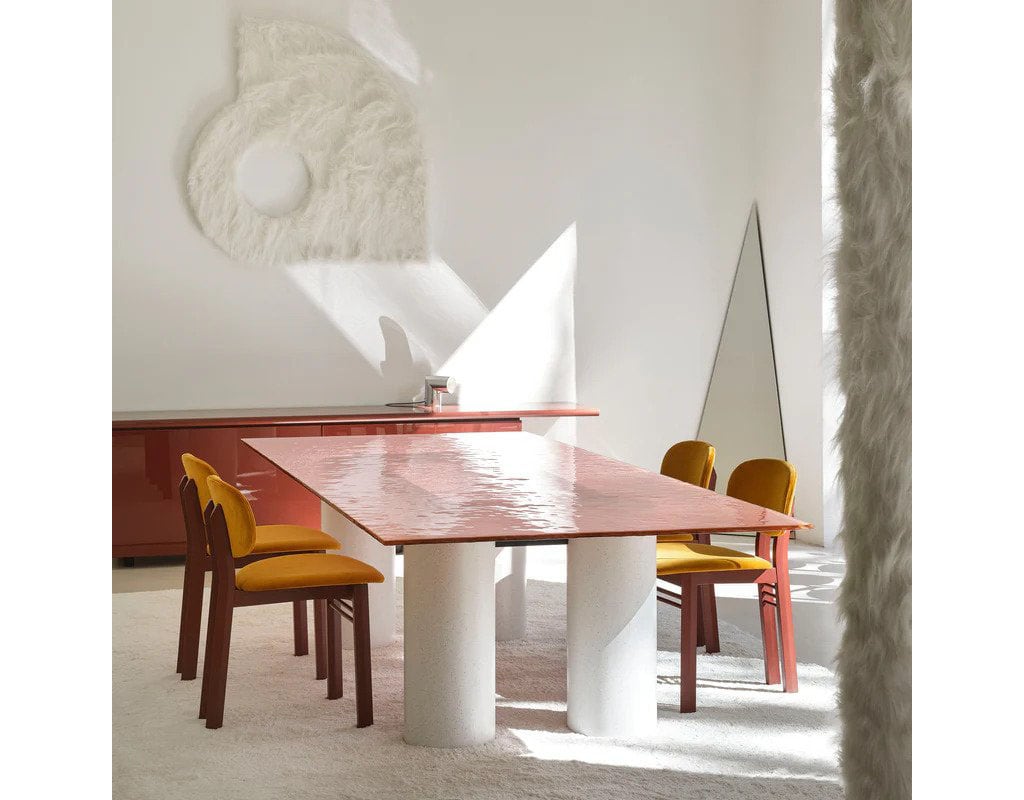 dining room chairs made with orange fabric and brown wood in a dining room.