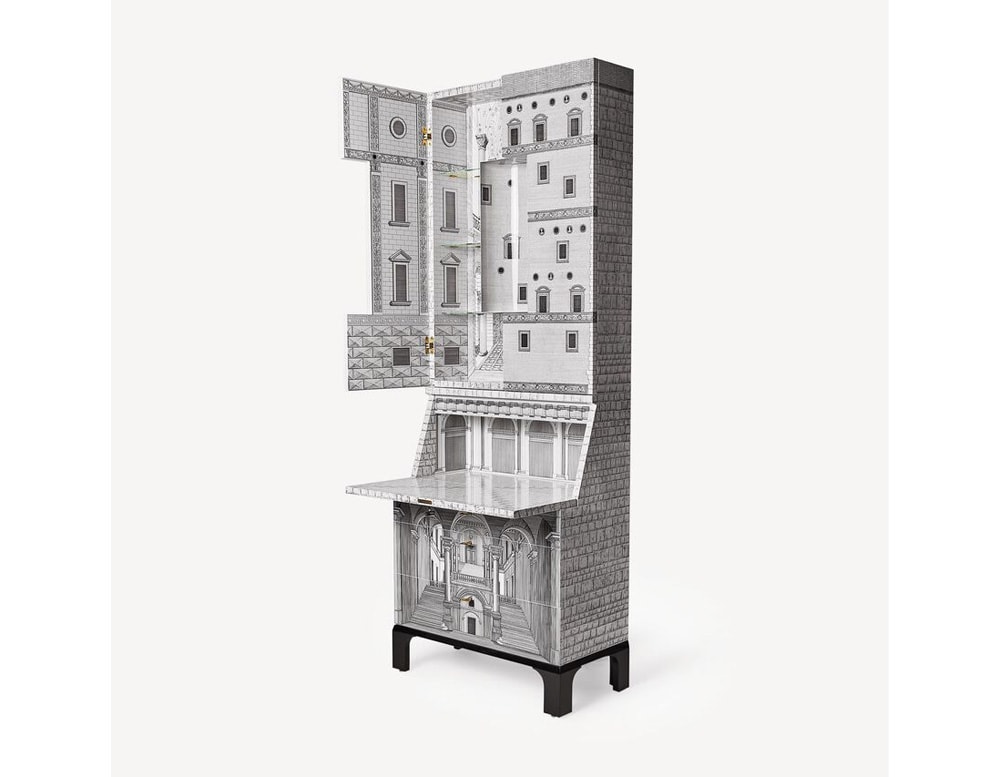 furniture with double doors in one of its three drawers with black and white house shape design